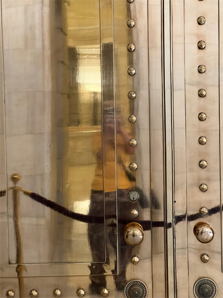 Karen Duquette's reflection in the bronze door