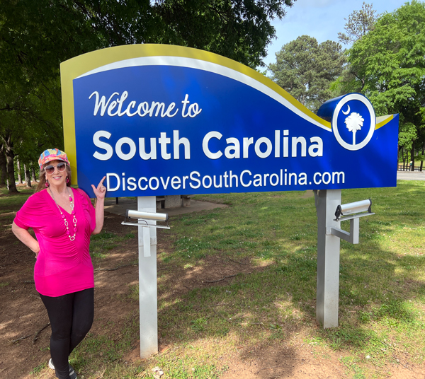 Karen Duquette at the Welcome to South Carolina sign