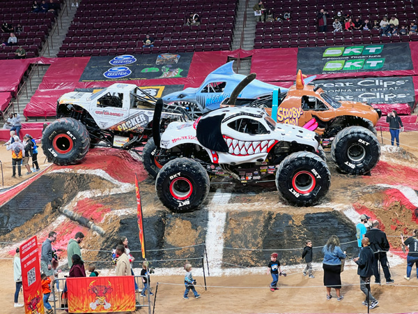 monster trucks in the center of the arena