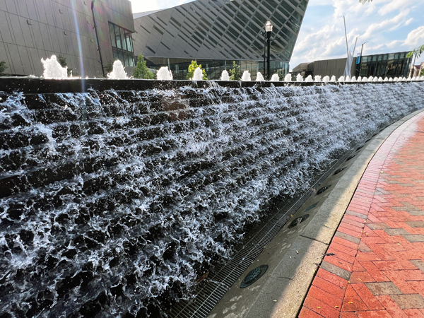 a long, slightly curved wall with a cascading water feature