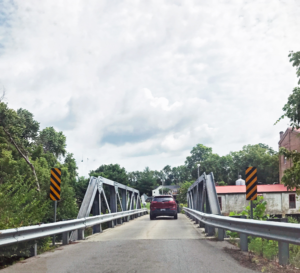 car on narrow bridge