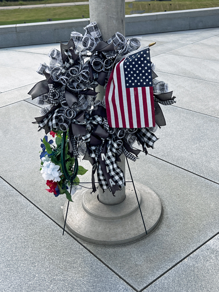 flowers, USA flag by pole