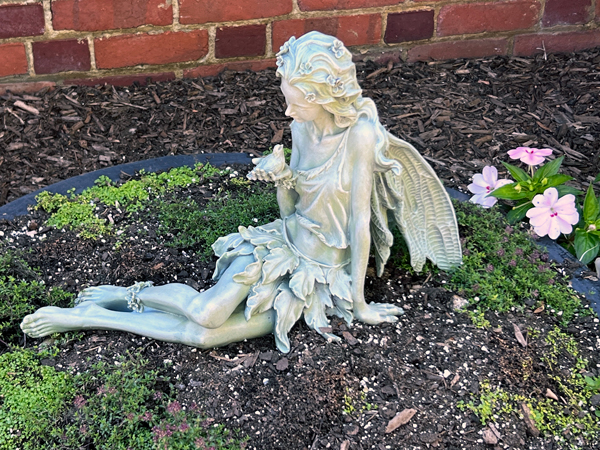 Angel statue with a bird in hand