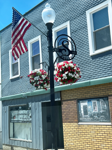 USA flag, flowers and shebly sign