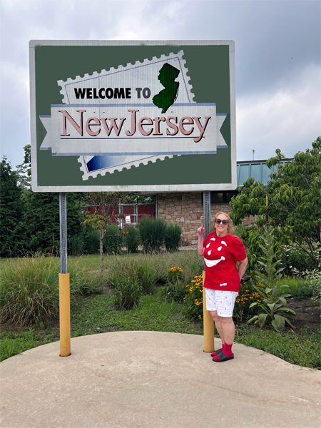 Karen Duquette at the Welcome to New Jersey sign