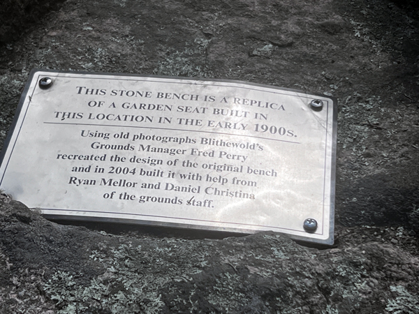 sign about the stone bench