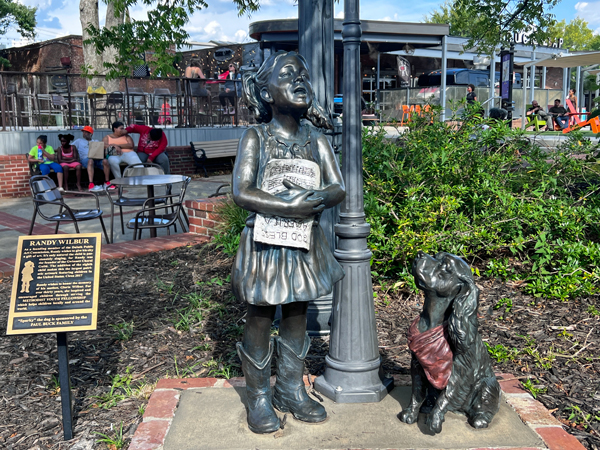 Sparky the dog and a child singing statue