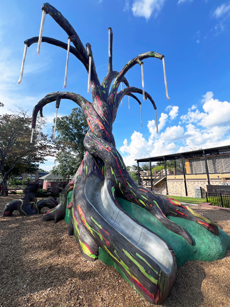 colorful sculptured tree and slide