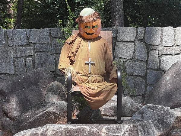 Holy pumpkin man in a chair