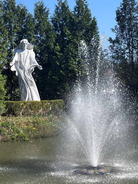 Healing Christ statue and a water fountain