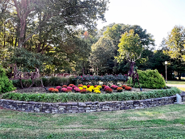 deer sculptures and flowers