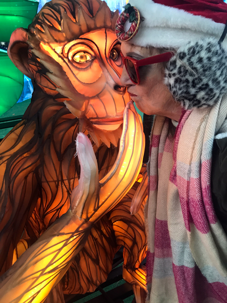 Karn Duquette kissing a monkey