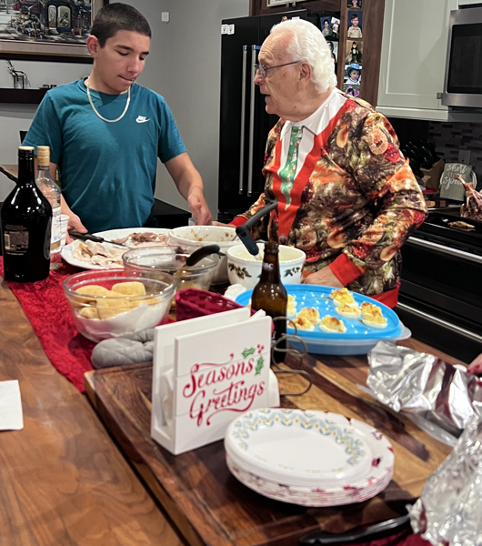 Anthony and his great-grandfather at the food table