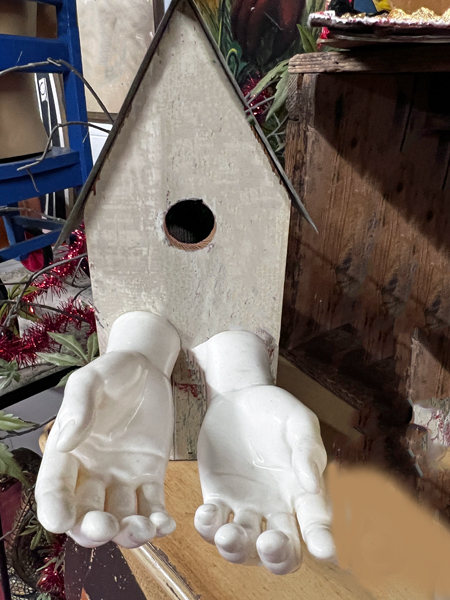 birdhouse with human hands