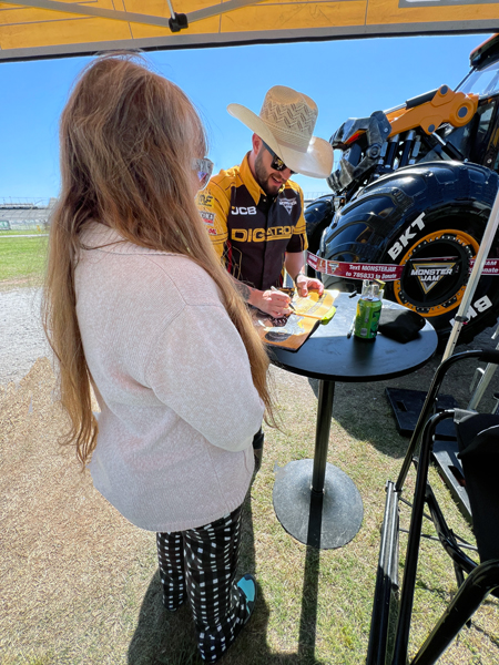 Tristen England signing Karen Duquette's Monster Jam book