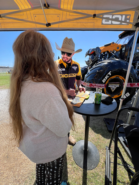 Tristen England signing Karen Duquette's Monster Jam book