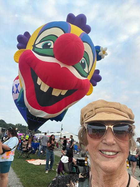The giant clown balloon snuck-up behind Karen Duquette