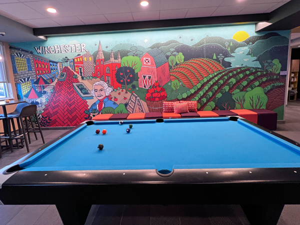 Pool table and mural in hotel lobby