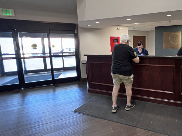 Lee Duquette registering at the hotel