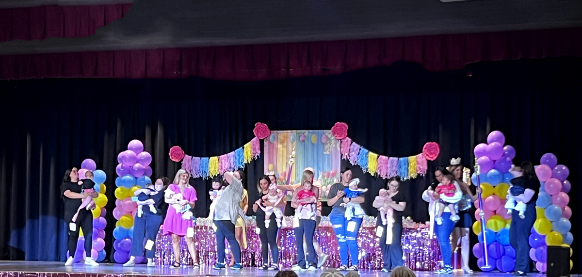 babies and moms on stage