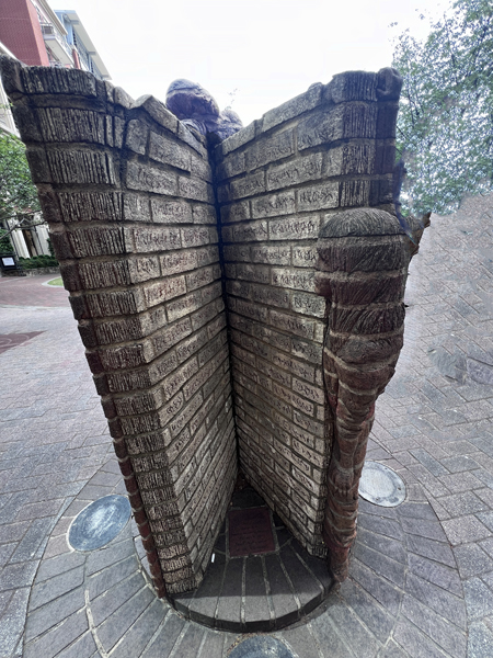 Boys climbing a brick wall