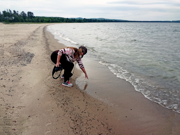 Karen Duquette at Pancake Bay Provincial Park feeling the water temperature