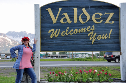 Karen Duquette and a welcome to Valdez sign