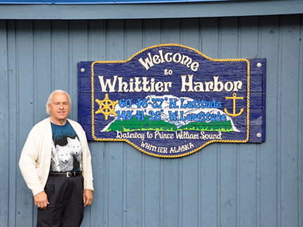 Lee by the welcome to Whittier Harbor sign
