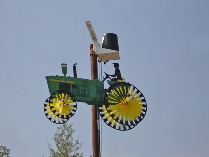 a lightpole and a "tractor" with spinning wheels