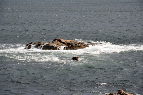 waves pounding boulders in the ocean