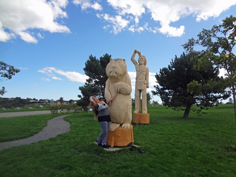 Karen Duquette by the wooden carving at Wolastoq Park
