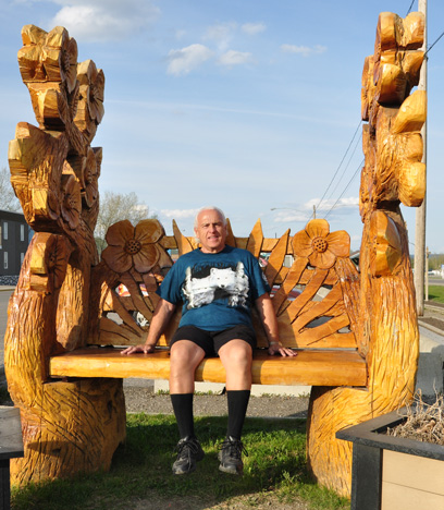 Lee sitting on a sculptured bench