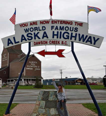 Karen Duquette and the sign - entering the World Famous Alaska Highway