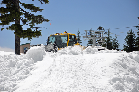 A SNOW PLOW HARD AT WORK ON GROUSE MOUNTAIN