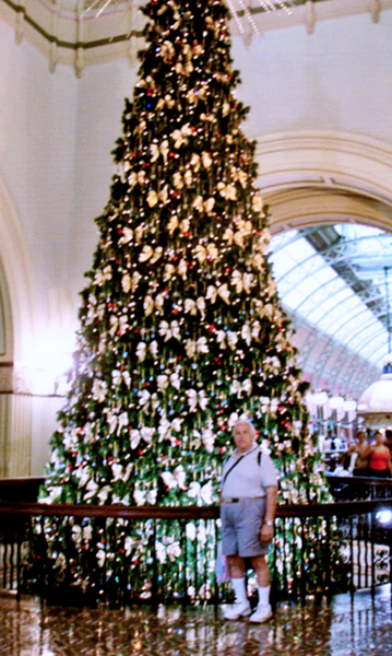 Lee  Duquette and a tall Christmas tree