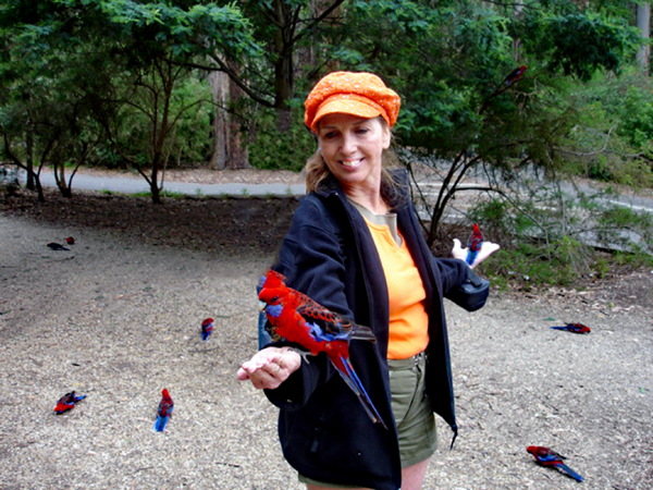 Karen Duquette feeding a bird