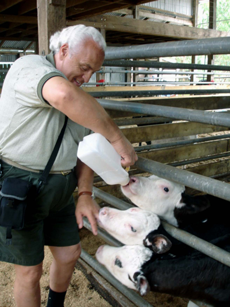 Lee Duquette offering a calf some milk
