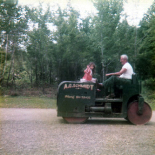 Renee Duquette on a tractor building the driveway