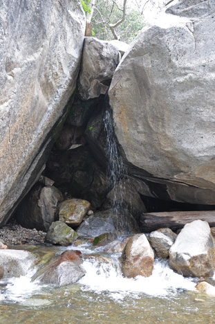 a small spring flowing down the boulders
