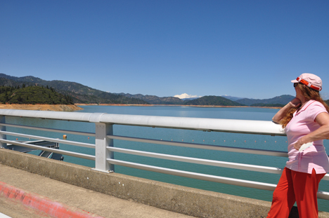 Karen Duquette looking at Shasta Lake and Mt. Shasta from the bridge