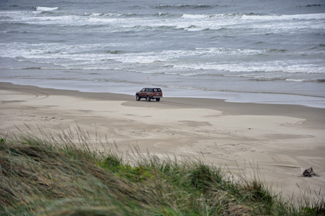 Looking at a jeep on the beache top of the sand dune