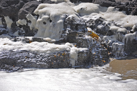 white froth splashes upon the rocks