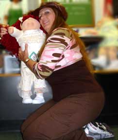 Karen Duquette hugs a Cabbage Patch doll