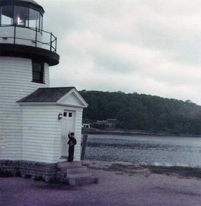 Brian Lee Duquette in front of the lighthouse at Mystic Seaport