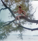 Brian in a tree over a lake