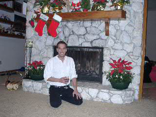 Brian by the fireplace in his home